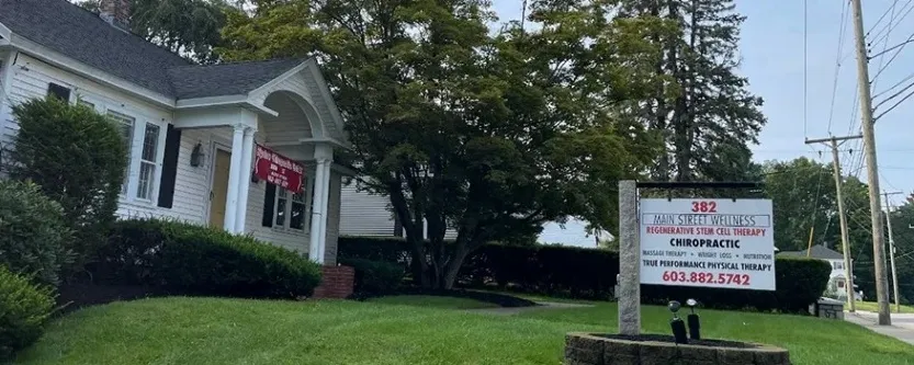 Chiropractor reviewing patient posture and pain during first visit in Nashua NH