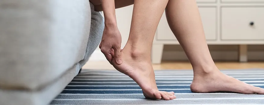 Person experiencing plantar fasciitis heel pain first thing in the morning