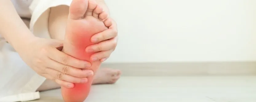 Person experiencing neuropathy symptoms including burning and tingling feet