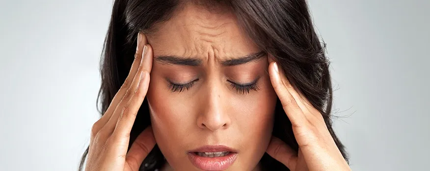 Chiropractor evaluating a patient with tension headaches and neck pain at Main Street Wellness in Nashua.